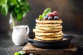 Pancakes with berries and maple syrup. Sweet homemade stack of pancakes