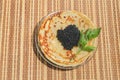 Pancakes with black caviar