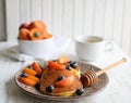 Pancakes with blueberries and apricots closeup