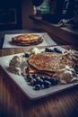 Pancakes with blueberries, cream and maple syrup Royalty Free Stock Photo