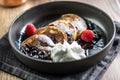 Pancakes with blueberry jam and raspberries in a bowl