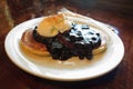 Pancakes with blueberry sauce dessert on white plate Royalty Free Stock Photo