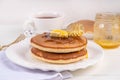 Pancakes with butter and honey or maple syrup drizzles