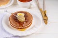 Pancakes with butter and honey or maple syrup drizzles