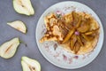 Pancakes with caramel pears. Horizontal, rustic style. Gray stone background. Close-up. Top view