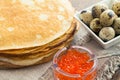 Pancakes with caviar and quail eggs