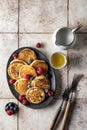 Pancakes in ceramic plate with berries and forks, top view Royalty Free Stock Photo