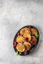 Pancakes in ceramic plate with berries, mint leaves, top view Royalty Free Stock Photo