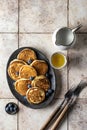 Pancakes in ceramic plate with blueberry, gravy boats and forks, top view Royalty Free Stock Photo