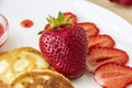 Pancakes with cheese and strawberries and sauce on a white dish against wood background. Delicious cheese pancake and strawberries Royalty Free Stock Photo