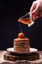 Pancakes with Chinese apples jam and pouring syrup on top