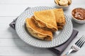 Pancakes with chocolate banana filling. Concept delicious breakfast, a white wooden table