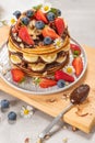 Pancakes with chocolate paste and hazelnuts, banana, strawberry and blueberry. Royalty Free Stock Photo