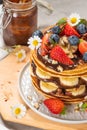 Pancakes with chocolate paste and hazelnuts, banana, strawberry and blueberry Royalty Free Stock Photo