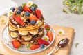 Pancakes with chocolate paste and hazelnuts, banana, strawberry and blueberry Royalty Free Stock Photo