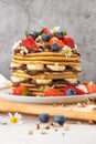 Pancakes with chocolate paste and hazelnuts, banana, strawberry and blueberry. Royalty Free Stock Photo