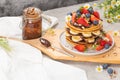 Pancakes with chocolate paste and hazelnuts, banana, strawberry and blueberry. Royalty Free Stock Photo
