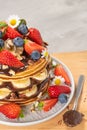 Pancakes with chocolate paste and hazelnuts, banana, strawberry and blueberry. Royalty Free Stock Photo