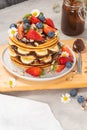 Pancakes with chocolate paste and hazelnuts, banana, strawberry and blueberry Royalty Free Stock Photo