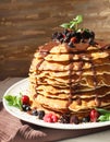 Pancakes with chocolate syrup and berrie fruits