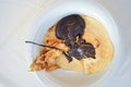 Pancakes with chocolate on a white plate. Healthy eating traditional breakfast. View from above