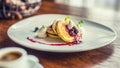 Pancakes and coffee. Pancakes with a cup of coffee and fresh fruits blueberries and herb decoration.