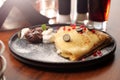 Pancakes with cottage cheese, served with fresh fruit, whipped cream and chocolate, close-up, selective focus. Royalty Free Stock Photo