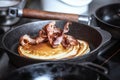 Pancakes with crispy bacon in cast iron skillet, frying pan. Morning Breakfast. Royalty Free Stock Photo