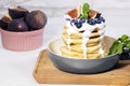 Pancakes with Fig, Blueberry, Youghurt and Mint in pan on white background, Healthy Eating Concept, Traditional American Breakfast