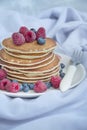 Pancakes with fresh berries on a light background. Pancakes with fruits. Traditional american crepes. Summer homemade breakfast.