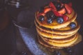 Pancakes with Fresh Berries and Maple Syrup on Dark Background Royalty Free Stock Photo