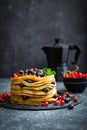 Pancakes with fresh berries and maple syrup on dark background Royalty Free Stock Photo