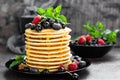 Pancakes with fresh berries. Pancakes with raspberry, blueberry, black currant and honey