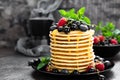 Pancakes with fresh berries. Pancakes with raspberry, blueberry, black currant and honey