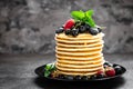 Pancakes with fresh berries. Pancakes with raspberry, blueberry, black currant and honey