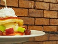 Pancakes with fresh fruits, whipped cream on glass table with Royalty Free Stock Photo