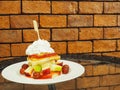 Pancakes with fresh fruits and whipped cream on glass table with Royalty Free Stock Photo