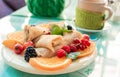 Pancakes with fruits on glass table for breakfast Royalty Free Stock Photo