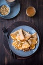 Pancakes with honey, bananas and pine nuts Royalty Free Stock Photo