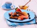 Pancakes and honey dipper on blue wooden