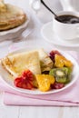 Pancakes with honey and heart shaped oranges and kiwi Royalty Free Stock Photo