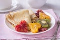 Pancakes with honey and heart shaped oranges and kiwi Royalty Free Stock Photo