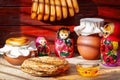 Pancakes with honey and matryoshka dolls are must-have accessories for Maslenitsa week, Russia