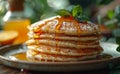 Pancakes with honey and mint on plate spoon knife fork on wooden table with cup of coffee jar of honey glass Royalty Free Stock Photo