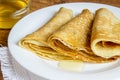 Pancakes with honey syrup on a white plate. traditional crepe or pancake