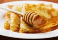 Pancakes with honey syrup on a white plate Royalty Free Stock Photo