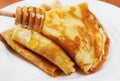 Pancakes with honey syrup on a white plate Royalty Free Stock Photo