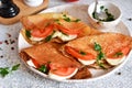 Pancakes with mozzarella and tomatoes with pesto on the kitchen table. Pancakes with caprese Royalty Free Stock Photo