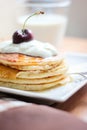 Breakfast whole wheat pancakes with cherry and yogurt