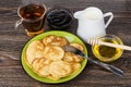 Pancakes in plate, bowl with honey, jam, milk and tea Royalty Free Stock Photo